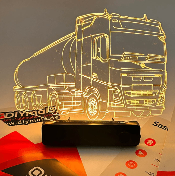 3D illusion LED night light in the shape of a tanker truck on a black base, glowing yellow