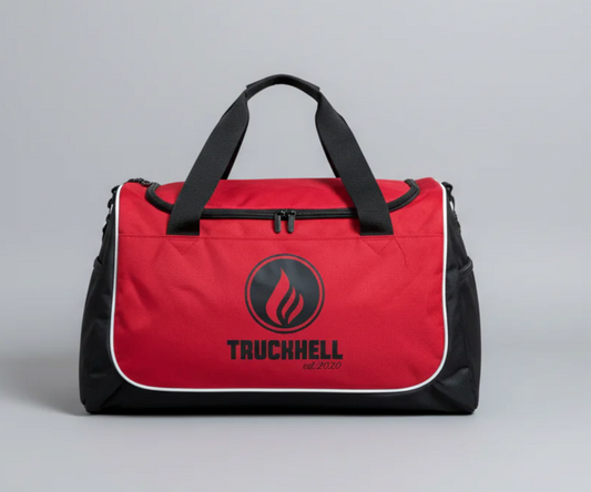 Red and black sports bag with flame logo and TRUCKHELL text, front view on gray background